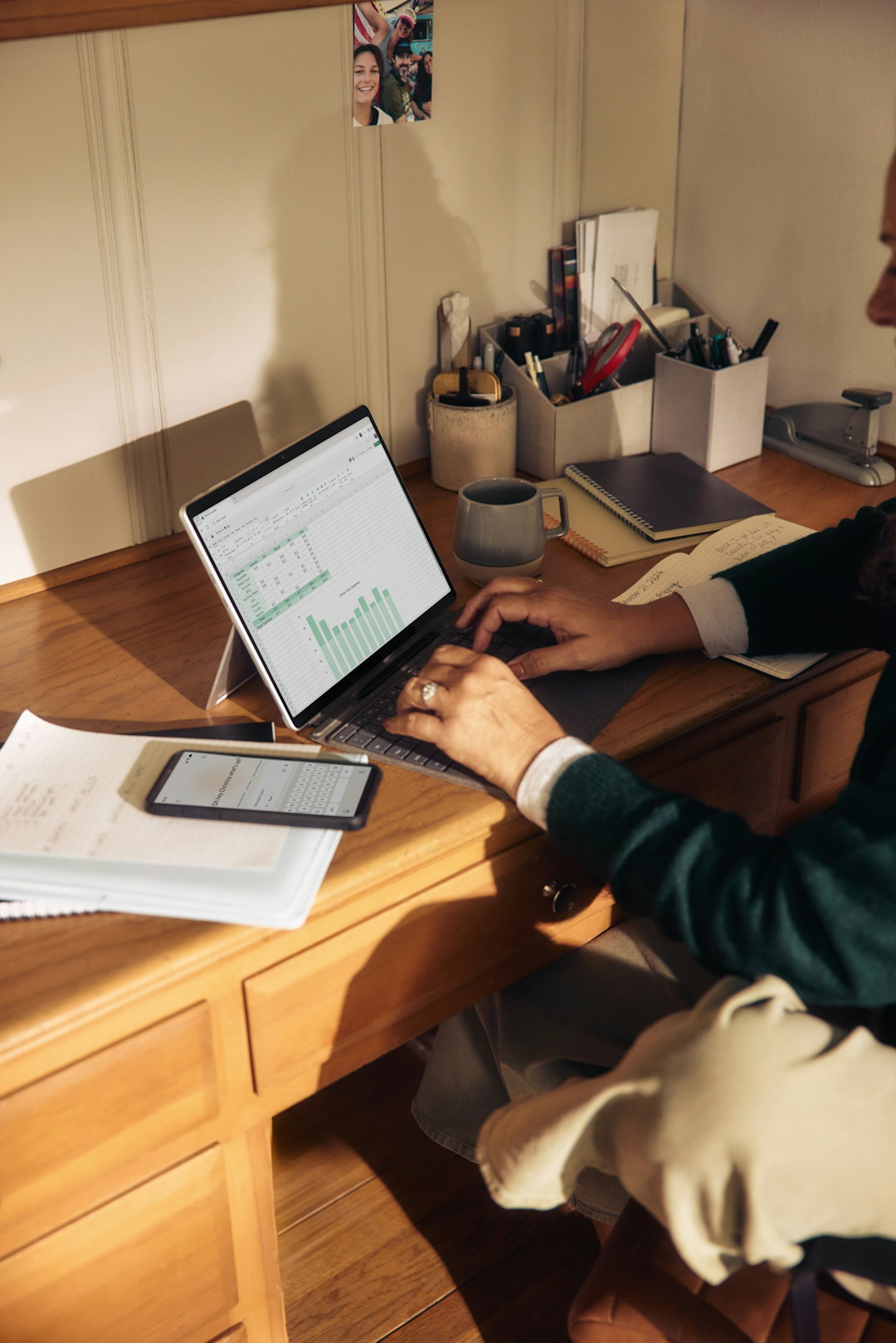 person-working-on-laptop-at-a-wooden-desk-.jpg Person working on laptop at a wooden desk.